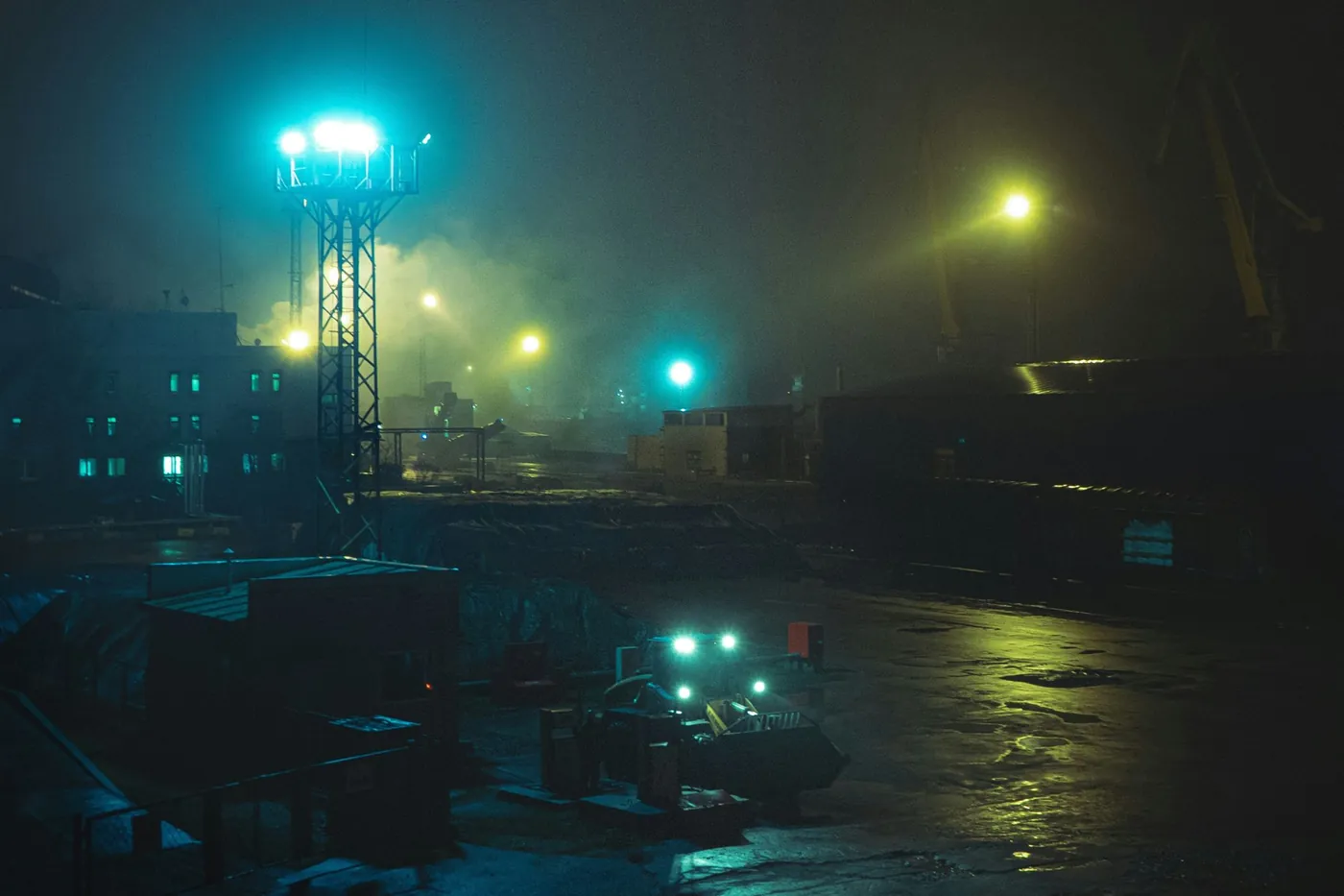 Industrial port at night under floodlights and fog